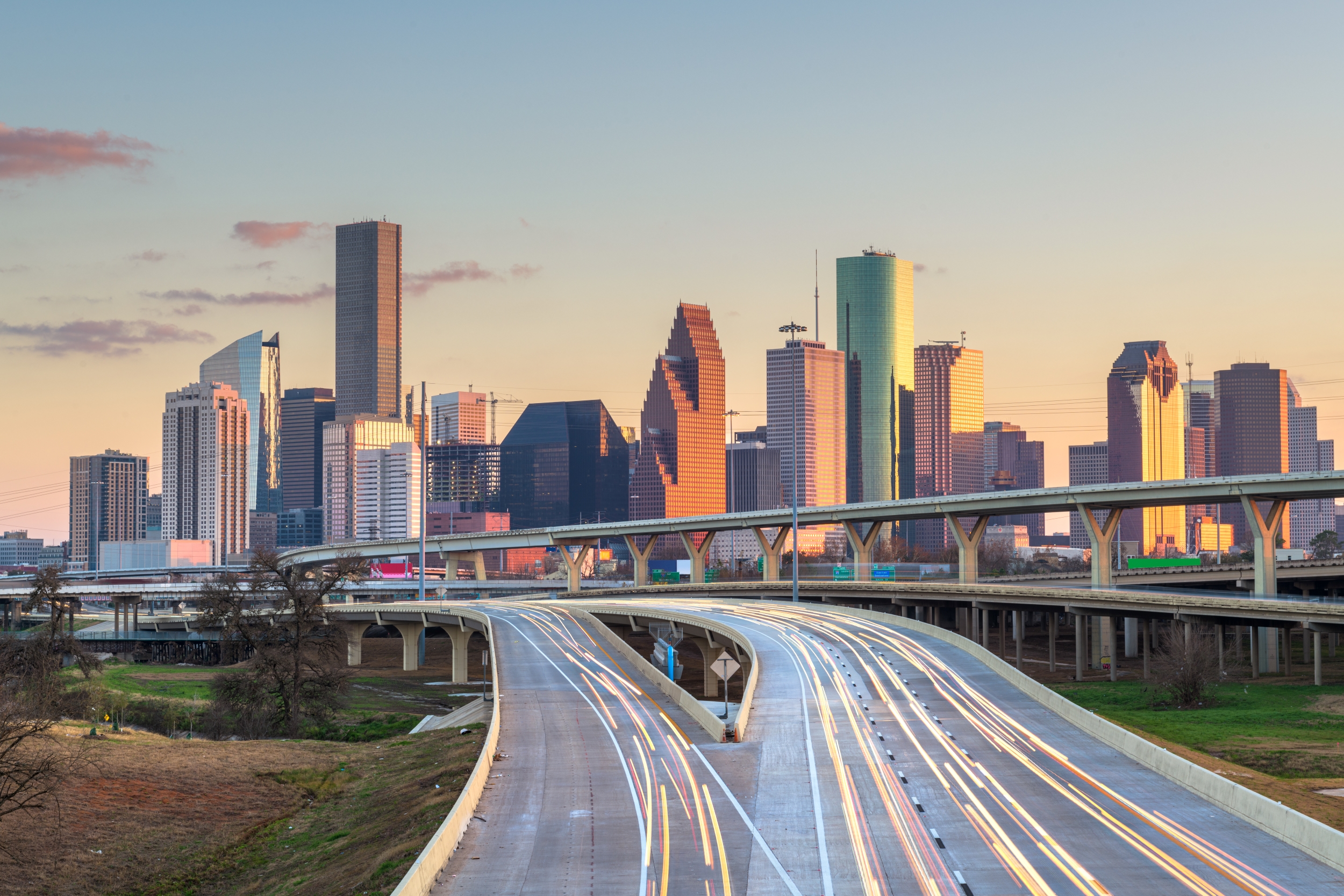 Houston, Texas, USA downtown skyline over the highways at dusk.