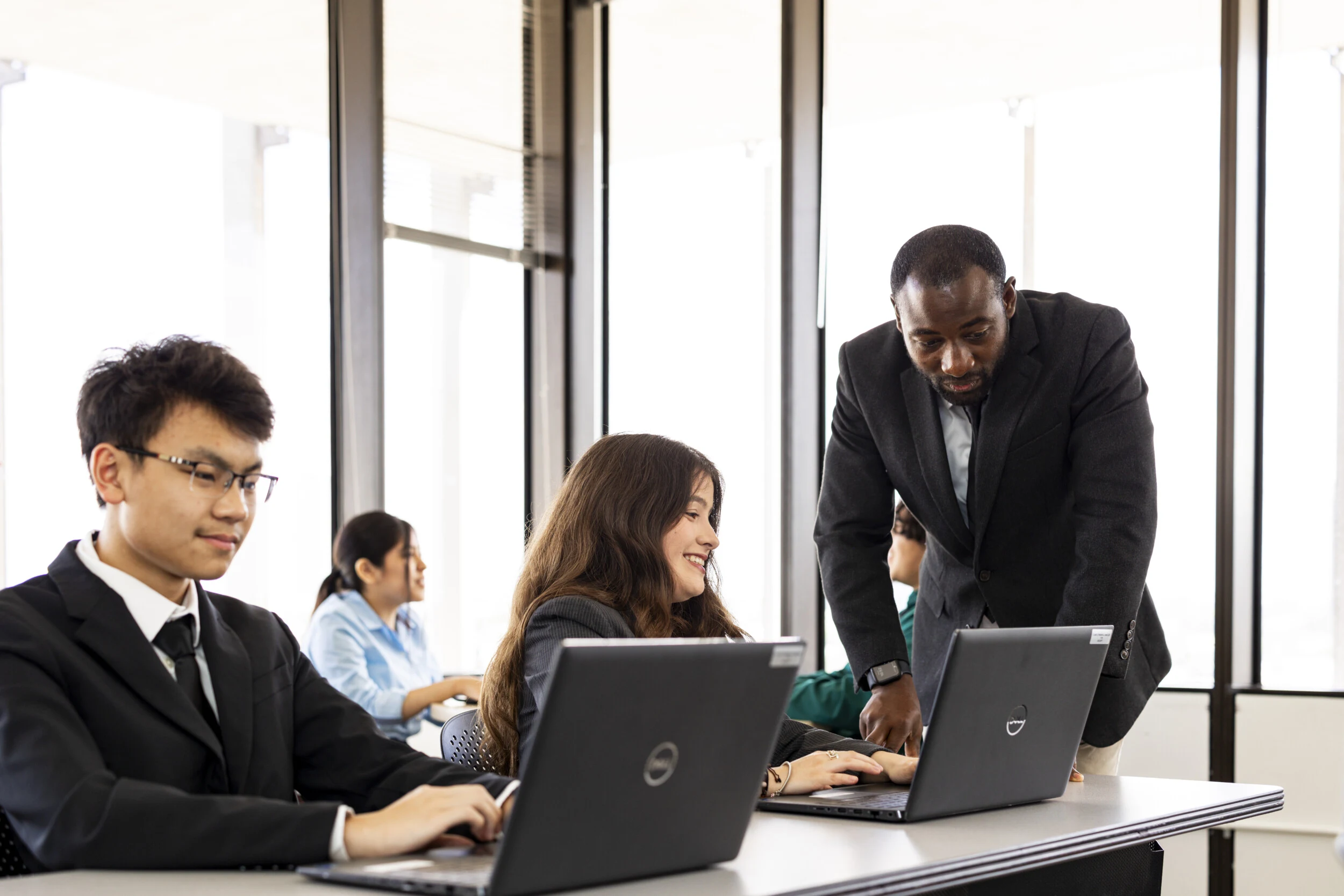 students and supervisors learning at computer