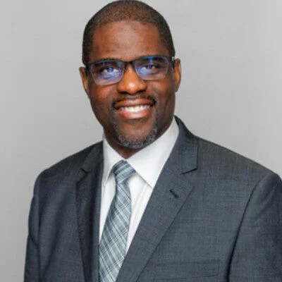 Man smiling and dressed in suit and tie